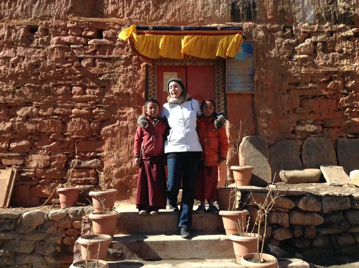 Foreigner taking a picture with two lama kid | Your local guide inside the red monastery